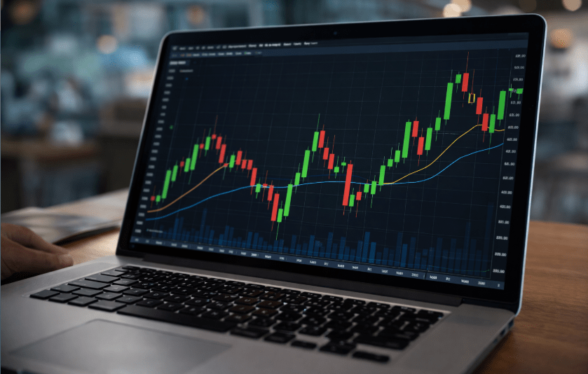 Candle stick chart on a laptop screen.